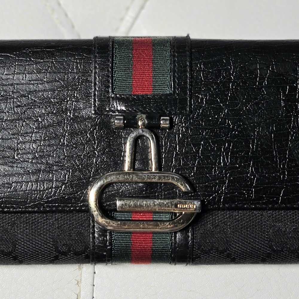 black Gucci leather and GG canvas long wallet with a green and red Web stripe.